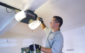 Contractor installing garage door liftmaster into ceiling