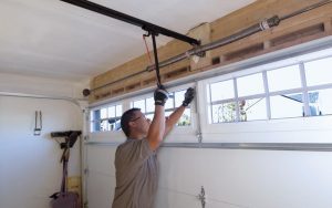 Contractor testing garage door after installation